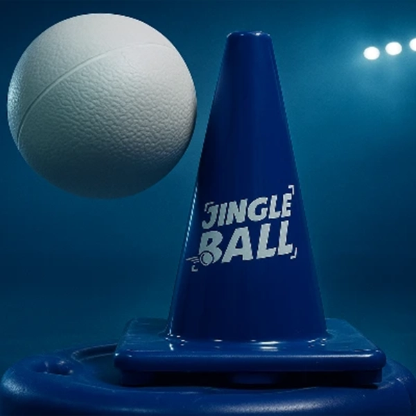 A blue traffic cone with "JINGLE BALL" printed on it, next to a white ball, against a dark blue background.